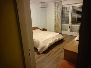a bedroom with a bed and a wooden floor at Guest house Vila Luka 2 in Portorož