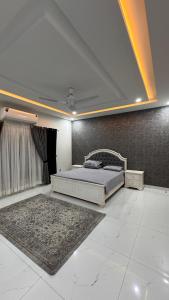 a large bedroom with a bed and a rug at Heston Villa Islamabad International Airport in Islamabad