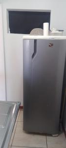 a small refrigerator in a kitchen with a counter at Qto privativo em Duplex a 5km do carnaval in Olinda