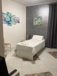 a bedroom with a bed and paintings on the wall at B&B da JOELE in Spinetta Marengo +10 photos