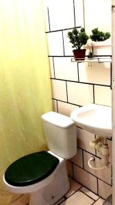 a bathroom with a white toilet and a sink at pousada mar azul in Salvador +24 photos