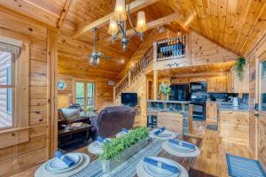 a log cabin living room with wooden walls and a ceiling at Mountain View Cabin - Hot Tub-Fire Pit-Pool Table in Mineral Bluff