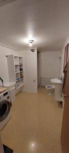 an empty bathroom with two toilets and a sink at Cozy apartment in Klaksvík
