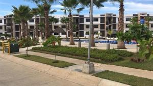 a street with palm trees and a building at Departamento en Mazatlán in Mazatlán