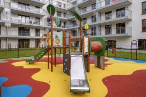 a playground in front of a apartment building at JHM Apart in Zakopane