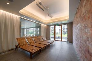 a row of benches in a room with windows at JHM Apart in Zakopane