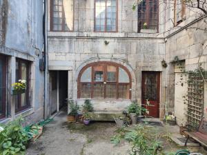 an old building with a bunch of plants in it at Studio cosy centre ville in Besançon