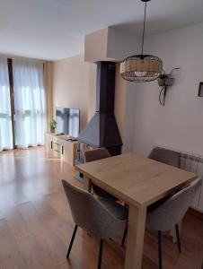 une salle à manger avec une table en bois et une cuisinière dans l'établissement El rincón del Pirineo, à Tramacastilla de Tena