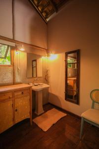 a bathroom with a sink and a mirror at Quinta de Caraíva in Porto Seguro +40 photos