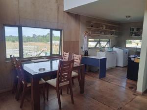a kitchen and dining room with a table and chairs at Casa en Huelmo in Puerto Montt