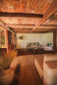 a living room with a couch and a table at Pousada Quinta de Caraíva in Porto Seguro +39 photos