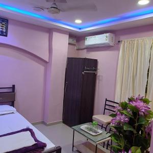 a room with a bed and a table and a table sidx sidx at A K Home's 2BHK flat in Hyderabad