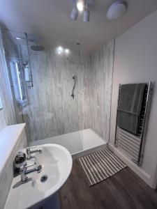 a bathroom with a sink and a shower at Orchard Side Bed and Breakfast in Great Malvern +78 photos