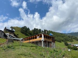 a building on top of a hill in a field at Mate's Space in Akhmety