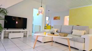 a living room with a couch and a table at HAPPY HOMES YELLOW - Up to 8 - Küche - W-LAN - Netflix - Honig - Badewanne in Nidda