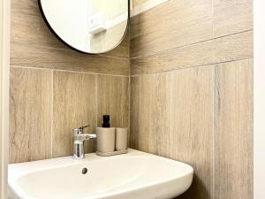 a bathroom with a white sink and a mirror at Casa Jazz Design & Relax nel Cuore di Perugia in Perugia +18 photos