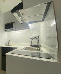 a kitchen with a sink and a counter top at Cityscape Tower 2 Condo in Midtown Cebu in Cebu City