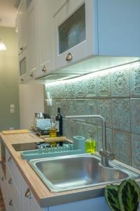a kitchen with a sink and a counter top at Cloe Corfu Town Apartment in Agios Rokkos +28 photos