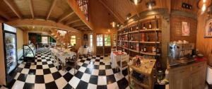 a large room with a checkered floor in a store at Hotel de los Castillos in Puerto Natales