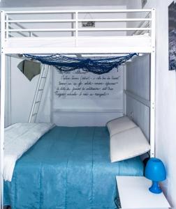a bunk bed in a room with a blue bed at BluBed Mare - Quadrupla Bagno Cucina e Balcone in San Giovanni Teatino