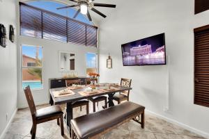 une salle à manger avec une table et des chaises et une télévision dans l'établissement Heritage Haven Villa, à Las Vegas