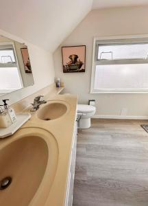 a bathroom with a sink and a toilet at Elmshade Villa in Vancouver South in Vancouver