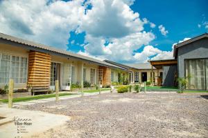 a row of buildings on a sunny day at Kanana Villas Maun 2 bedroom apartment in Maun