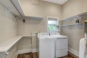 a white laundry room with a washer and dryer at 1016 San Fernando Street in Fernandina Beach +31 photos