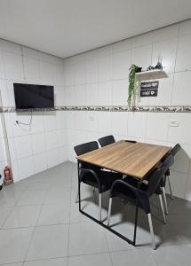 a conference room with a wooden table and chairs at Apartamento Bandeiras Local Tranquilo e Familiar in Osasco