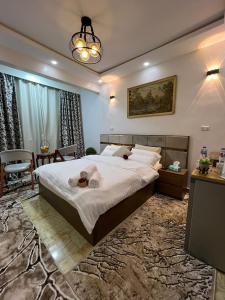 a bedroom with a large bed and a table at Moonlight golf view in Cairo +13 photos