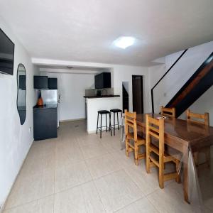 a kitchen and dining room with a wooden table and chairs at Espacioso dúplex, ubicación premium in San Luis