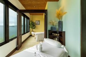 a bedroom with a bed and large windows at 360 Splendor 101B Ocean View Studio With Breakfast in Playa Flamingo