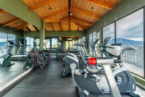 a gym with treadmills and a row of bikes at 360 Splendor 101B Ocean View Studio With Breakfast in Playa Flamingo +22 photos
