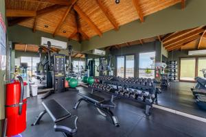 a gym with a lot of equipment in a room at 360 Splendor 101B Ocean View Studio With Breakfast in Playa Flamingo
