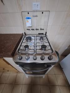 a stove top oven sitting in a kitchen at CASA - 3 quartos com ar - garagem para 3 carros in Campo Grande +52 photos