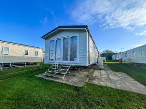 a tiny house with a ladder in a yard at Stunning Caravan For Hire Nearby Hunstanton Beach In Norfolk Ref 23050S in Hunstanton