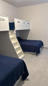 a room with two beds and a staircase in it at Casa Residencial Coral in San Carlos +10 photos