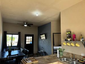 a kitchen and dining room with a ceiling fan at Departamento #1 Loma Bonita in Loreto