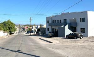 an empty street with cars parked on the side of a building at Departamento #1 Loma Bonita in Loreto +12 photos