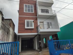 a building with a blue fence in front of it at Sri Adhinath Homes in Kanchipuram