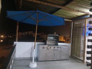 a blue umbrella sitting on top of a stove at Macky'sThe Silence in Bombiso