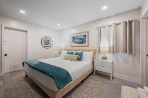 a white bedroom with a bed and a window at Heated Pool, Lush Breezeway, Bikes, BBQ, Near Beach in Merritt Island +38 photos