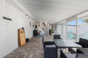a dining room with a table and chairs at Heated Pool, Lush Breezeway, Bikes, BBQ, Near Beach in Merritt Island