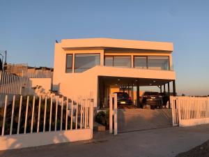 a house with a car parked in the driveway at Pingel Home Vista Mar in Valparaíso