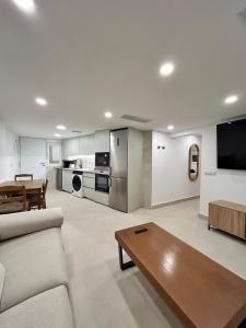 a living room with a couch and a table at AeroSuites201 Alojamiento Madrid in Madrid