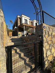 a gate in front of a house at Villa Carian Trail evdatca - Datca Kargi Bay, Close to Beach in Datca