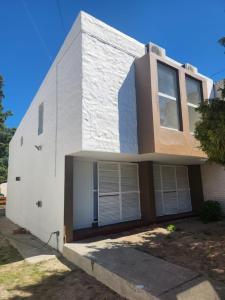 Casa blanca con 2 ventanas en Beautiful Casa Madrynense, en Puerto Madryn