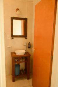 a bathroom with a sink and a mirror at Hosteria Alma de Patagonia in El Chalten +45 photos