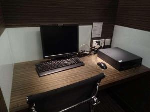 a desk with a computer and a laptop and a keyboard at Casa in Hong Kong