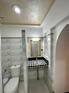 a bathroom with a toilet and a sink at RIAD dreams dades in Tamellalt +61 photos